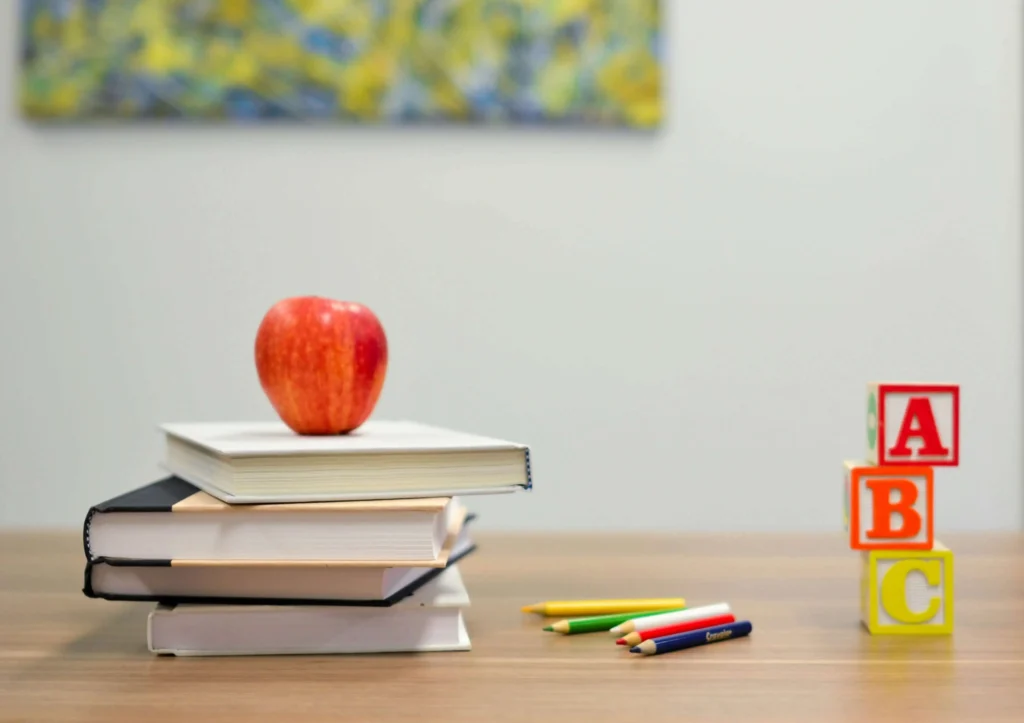 an apple on top of books